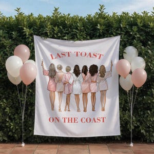 May include: A white banner with the text "LAST TOAST ON THE COAST" in red, featuring an illustration of eight women in robes, holding champagne flutes. Pink and white balloons are on either side of the banner, creating a celebratory atmosphere.