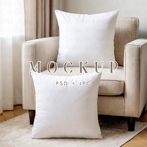 May include: Two white square pillows are displayed on a beige armchair and on the floor. The pillows are plain and have a soft, inviting appearance. The word "MOCKUP" is displayed in the center of the image, with "PSD + JPG" below it.