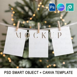 May include: Three white rectangular cards are pegged to a white string with wooden pegs. The word "MOCKUP" is displayed across the cards in large, elegant letters. The background is a blurred Christmas tree with fairy lights. The image includes the text "PSD SMART OBJECT + CANVA TEMPLATE".