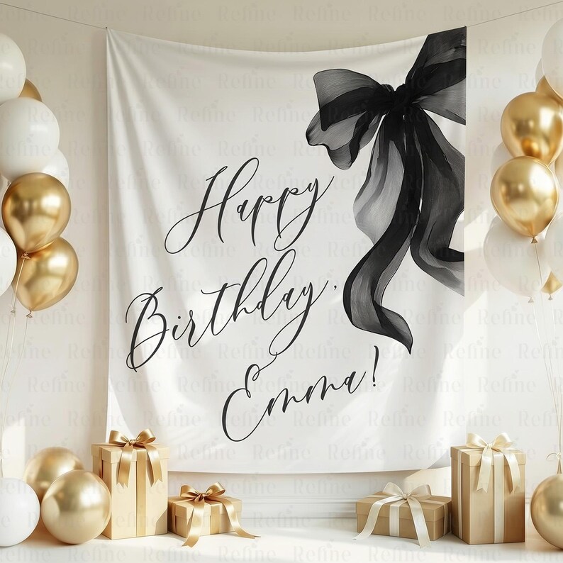 May include: A white backdrop with the words "Happy Birthday Emma!" in elegant script, accented by a large black bow illustration. Gold and white balloons and wrapped gifts complete the celebratory scene.
