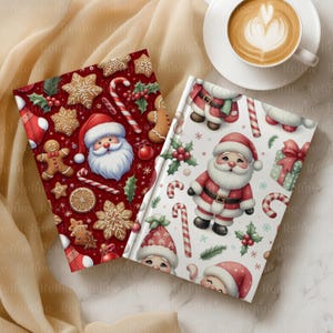 May include: Two Christmas-themed notebooks with festive designs. One features gingerbread men, snowflakes, and Santa Claus on a red background. The other has Santa Claus, candy canes, and gifts on a white background. A cup of coffee sits nearby.