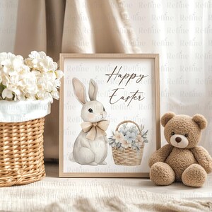 May include: A watercolor illustration of a white bunny holding a basket of blue and white flowers. The bunny is wearing a brown bow. The text "Happy Easter" is written in brown lettering on a white background.