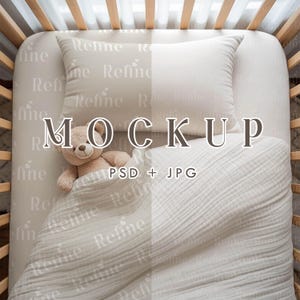 May include: A baby crib mockup featuring a beige teddy bear, pillow, and blanket. The bedding has a subtle 'Refine' pattern. The text 'MOCKUP PSD + JPG' is overlaid on the image. The crib is made of light-colored wood.
