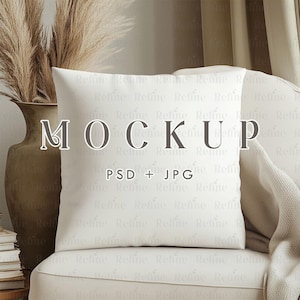 Puede incluir: Maqueta de cojín blanco sobre un sillón blanco con una manta beige. El cojín está en blanco y listo para tu diseño. El texto "MOCKUP" y "PSD + JPG" está impreso en el cojín.