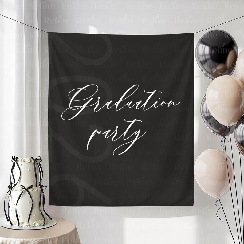 May include: A black backdrop with the words "Graduation party" in white script. A two-tiered white cake with black ribbon and balloons in black and beige are on the left and right sides of the backdrop.