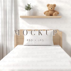 May include: A white bed with a wooden headboard and a white pillow. The bed is in a room with a white wall and a wooden shelf with a potted plant and a teddy bear on it. The text "MOCKUP PSD + JPG" is on the headboard.