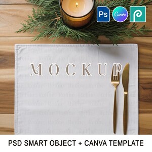 May include: A white rectangular placemat with the word "MOCKUP" in the center, accompanied by a gold fork and knife. A lit candle in a glass holder sits above the placemat, with evergreen sprigs and design software logos.