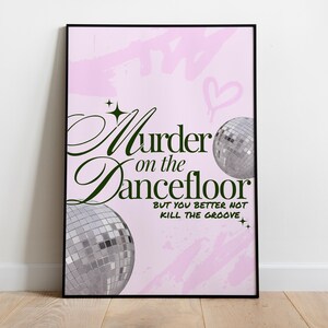 May include: A framed poster with a light pink background and the words "Murder on the Dancefloor" in dark green script. Two disco balls and the phrase "But you better not kill the groove" are also featured.
