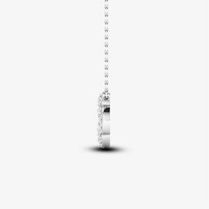 May include: A silver necklace with a heart-shaped pendant that is encrusted with small diamonds.