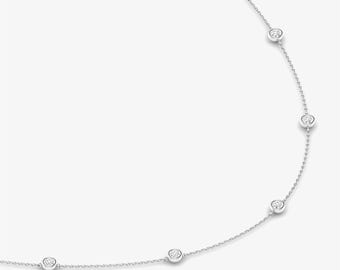 May include: A delicate silver chain necklace with five small round diamonds.