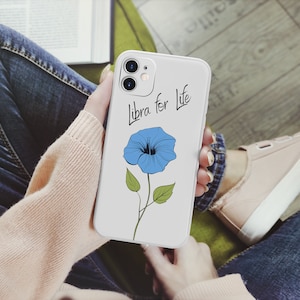 May include: A white phone case with a blue flower and the text "Libra for Life" printed on it.