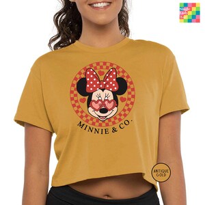 a woman wearing a minnie mouse crop top