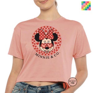 a woman wearing a minnie mouse crop top
