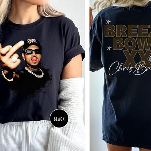 The image is a collage of two photos. In the left photo, a person is wearing a black t-shirt with a graphic of a man making a peace sign. In the right photo, the same person is wearing a black t-shirt with the text "Breezy Bowl XX" and "Chris Brown" printed on it.