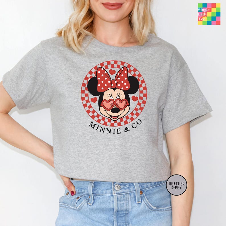 a woman wearing a minnie mouse t - shirt