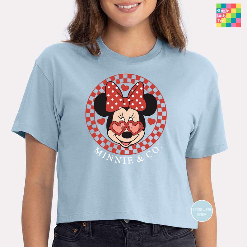 a woman wearing a blue minnie mouse shirt