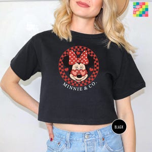 a woman wearing a minnie mouse crop top