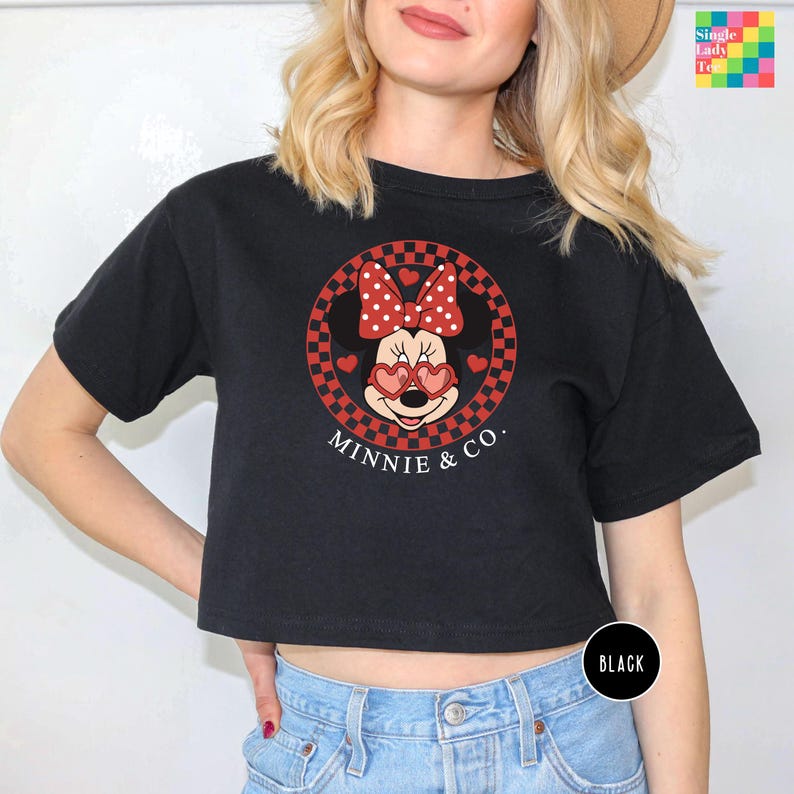 a woman wearing a minnie mouse crop top