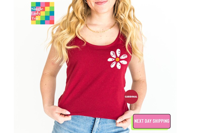 a woman wearing a red tank top with a flower on it
