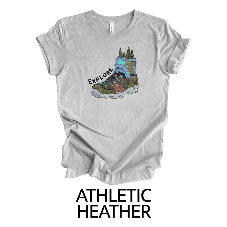 May include: Gray t-shirt with a graphic of a hiking boot with the word "EXPLORE" printed above it.