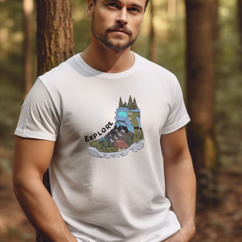 May include: White t-shirt with a graphic of a hiking boot with a mountain scene inside. The text "EXPLORE" is printed on the shirt.