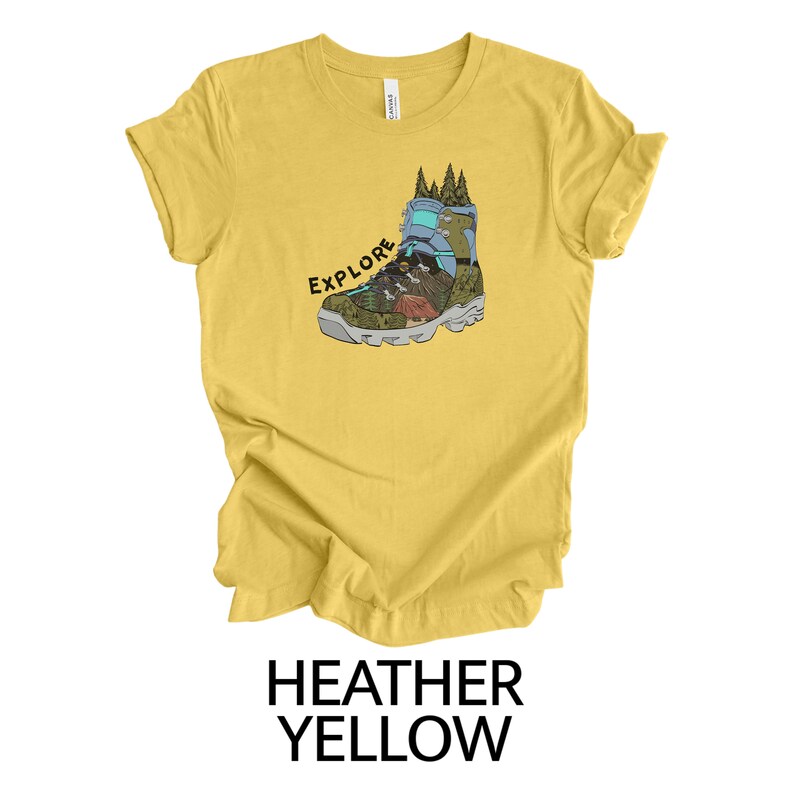 May include: A yellow heather t-shirt with a graphic of a hiking boot with the word "EXPLORE" printed on it.
