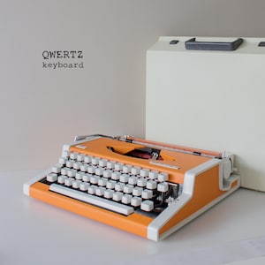 UNIS tbm de Luxe, working typewriter, orange typewriter, OLYMPIA Traveller, Graduation gift
