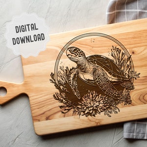 May include: A wooden chopping board with a laser-engraved design of a sea turtle swimming in coral. The turtle is brown and the coral is a light brown colour.