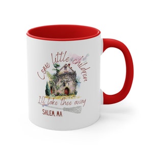 May include: White ceramic mug with a red rim and handle. The mug features a watercolor illustration of a house with vines, a broom, and the text "Come little children I'll take thee away SALEM, MA".