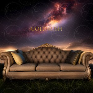 May include: A brown velvet sofa with gold accents sits in a field of green grass. The sofa has a tufted back and seat, and there are two pillows on the seat. The background is a dark purple sky with a bright orange and pink galaxy.
