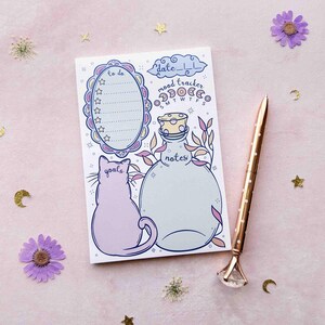 This photo shows an overhead view of the pastel notepad version with a pen next to it for scale.
