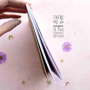 This photo shows the side view of the notepad with the text, there are 50 pages in this handmade notepad