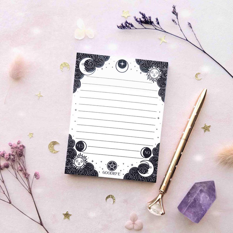 This photo shows an overhead view of the black and white version of this notepad with a pen for scale.