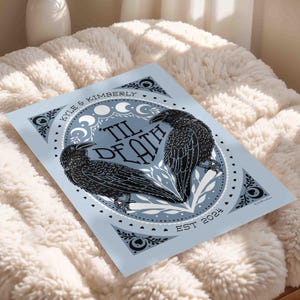 Unframed matte print that features 2 ravens in the shape of a heart & the words, “til death” in the center. Moon phases, botanical illustrations and hearts surround the ravens. The couple’s first names and anniversary date are arched on top and bottom