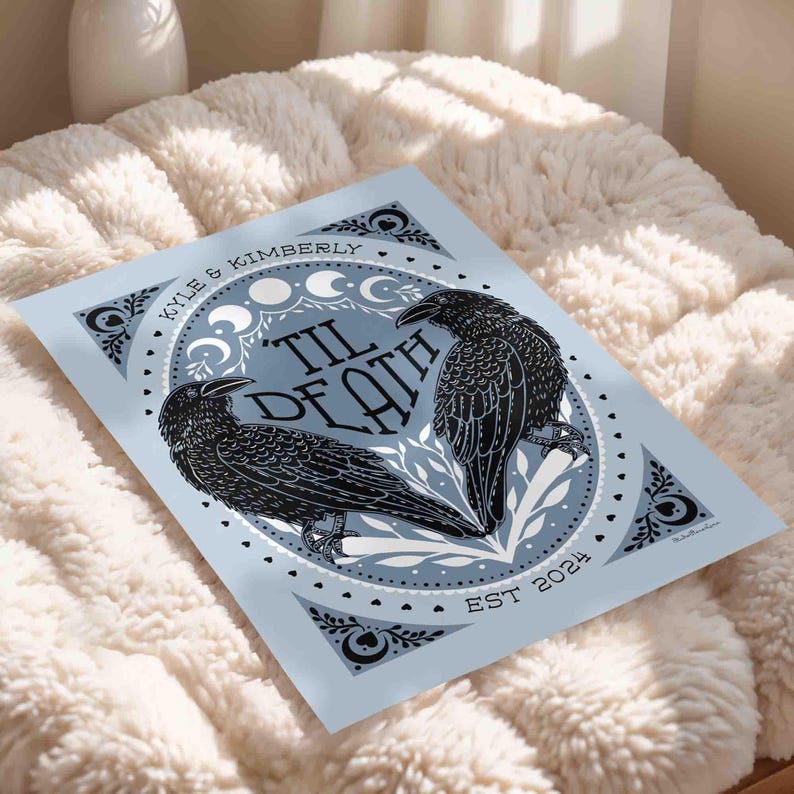 Unframed matte print that features 2 ravens in the shape of a heart & the words, “til death” in the center. Moon phases, botanical illustrations and hearts surround the ravens. The couple’s first names and anniversary date are arched on top and bottom