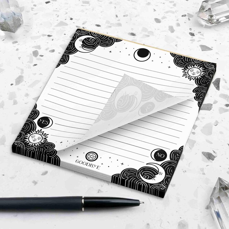 This photo shows the 5.5 by 6 inch spirit board notepad next to a pen