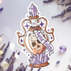 Aqua Tofana sticker that is an illustration of a potion bottle with lavender crystals on the top and bottom, copper-colored metal handles, and a skull floating in the deadly poison. A tag with the poison’s name is attached to the illustrated bottle