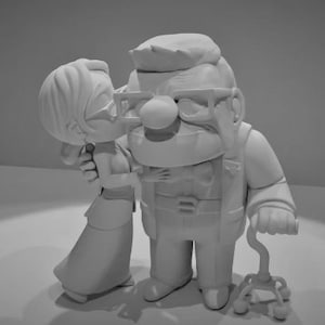 May include: A black and white figurine of an elderly couple. The man is wearing glasses and a bow tie. The woman is kissing him on the cheek. The man is holding a cane.