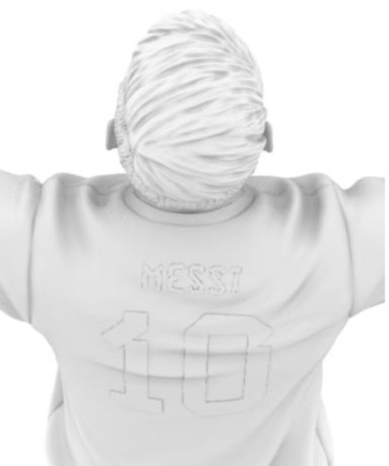 May include: White figurine of a person wearing a white jersey with the name "Messi" and the number "10" on the back.