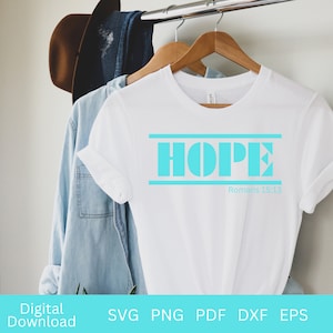 May include: White t-shirt with the word "HOPE" in turquoise blue letters with a turquoise blue line above and below the word. The text "Romans 15:13" is printed in black below the word "HOPE".