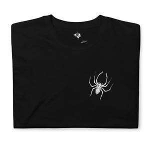 May include: Black t-shirt featuring a white spider graphic. The spider is centrally positioned on the shirt and is facing to the right. The shirt is made from a soft, comfortable material.