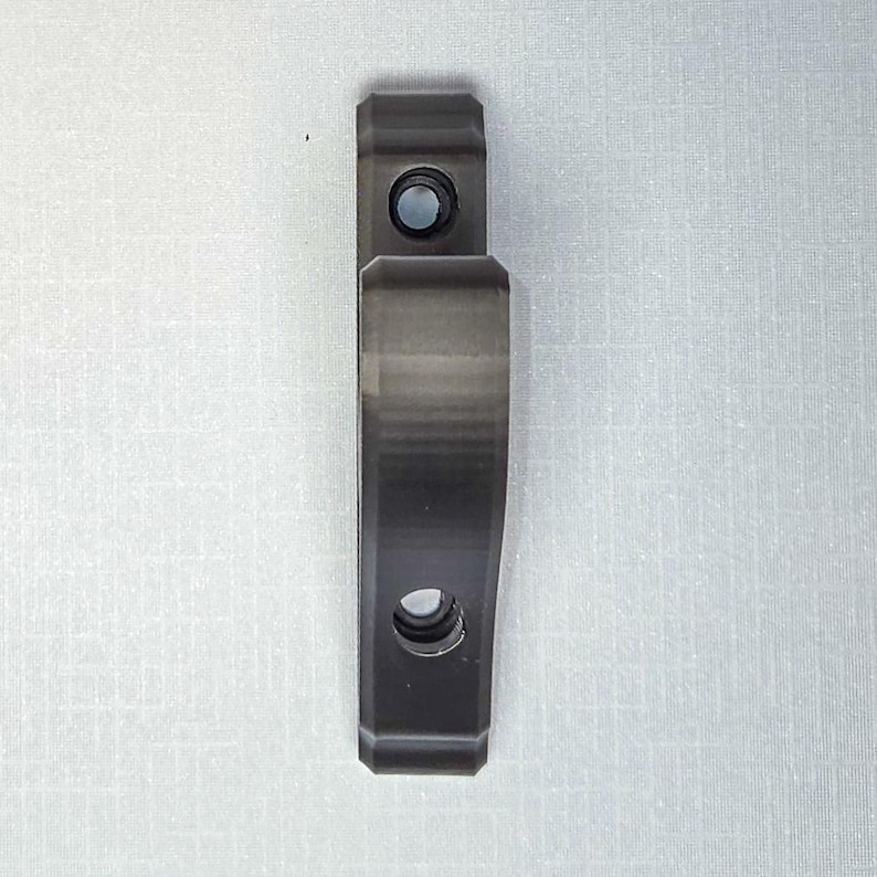 Close-up view of a single black horizontal sword wall mount against a light background. The compact, durable bracket shows pre-drilled holes for easy installation, designed to securely hold swords, katanas, and collectibles in place while keeping a clean, minimalist look.
