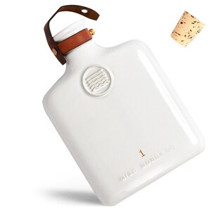 May include: White ceramic flask with a brown leather strap and a cork stopper. The flask has a raised logo with the text "MISC GOODS CO" and the number "1".