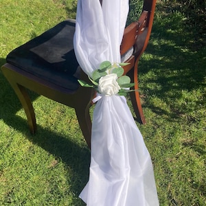 Pew Ends verticle Chair Drapes in white with flower and foliage adornment wedding stair chair decor