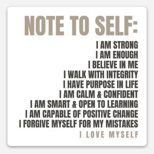 May include: A square white sticker with the text "NOTE TO SELF:" in a light brown font. Below, a list of affirmations in a dark brown font, including "I AM STRONG" and "I LOVE MYSELF."