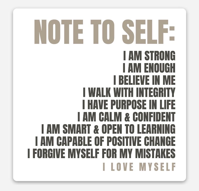 May include: A square white sticker with the text "NOTE TO SELF:" in a light brown font. Below, a list of affirmations in a dark brown font, including "I AM STRONG" and "I LOVE MYSELF."