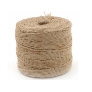 May include: A roll of natural brown twine, made from jute fibers, is wound tightly on a spool. The twine is a natural color and has a rough texture.