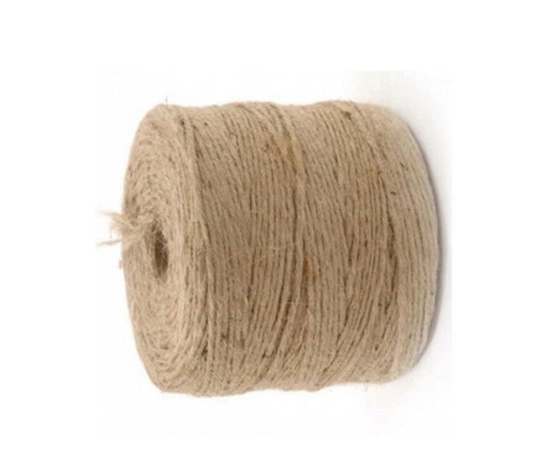 May include: A roll of natural twine, made from jute fiber, is a natural brown color. The twine is wound tightly on a spool.