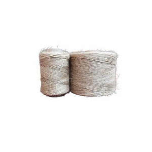 May include: Two spools of natural beige twine, wound tightly together.
