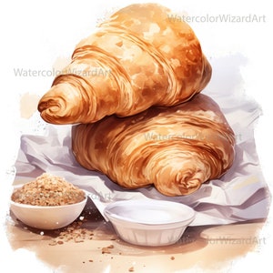 May include: Two golden brown croissants stacked on top of each other on a white parchment paper. A small white bowl filled with brown sugar is in the foreground.